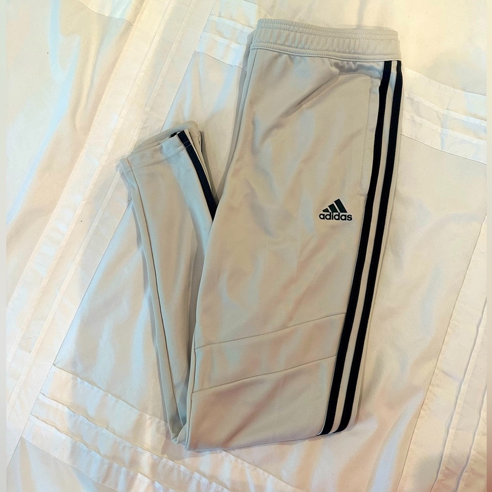 NWT. Adidas women striped pant with pockets and side zip on legs.